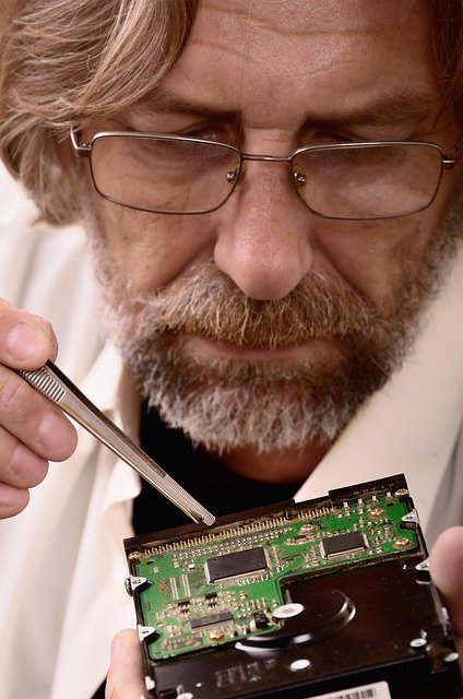 Técnico realizando diagnóstico em componente de computador, ilustrando reparo de PC gamer que não liga